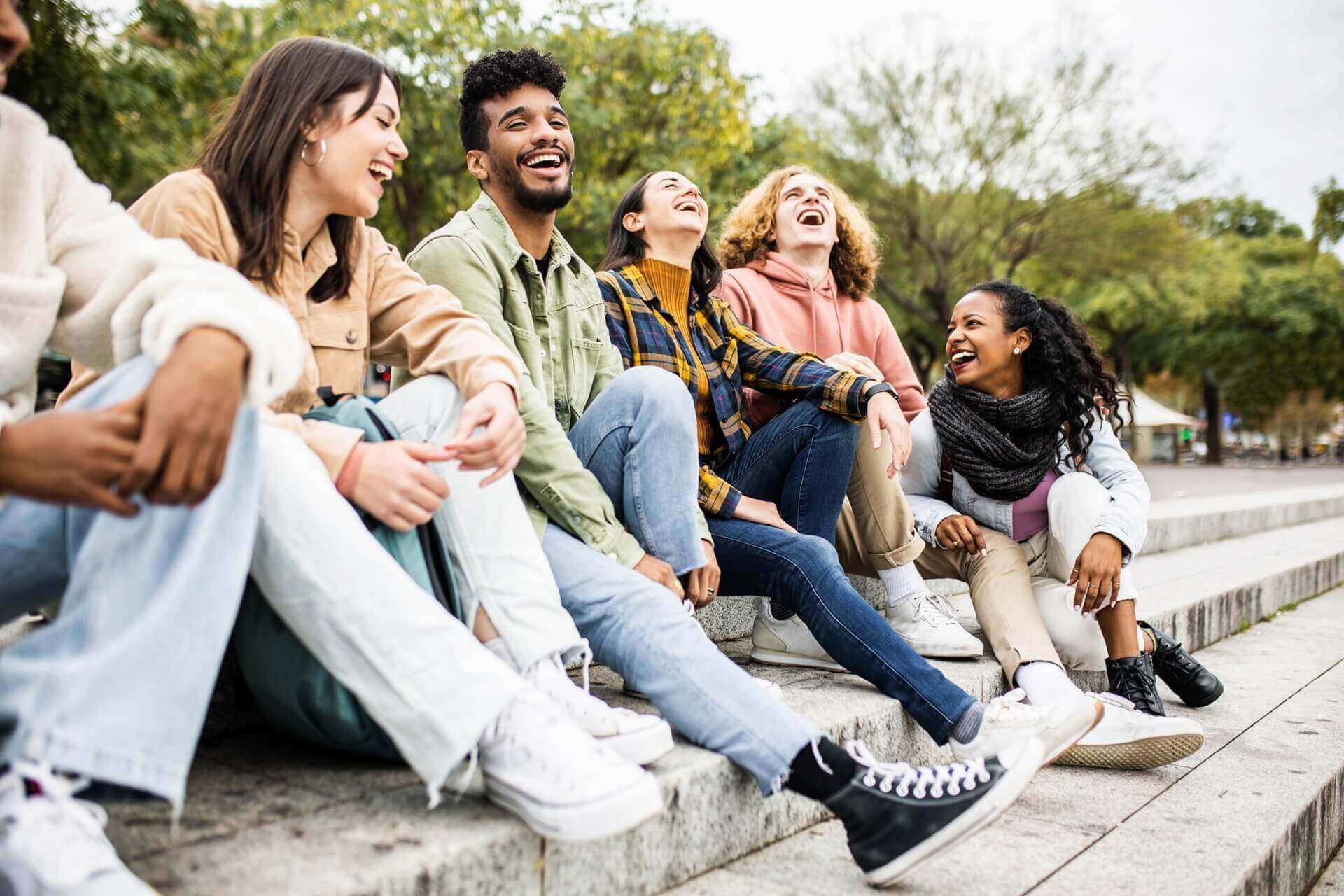 Multiracial group of young teenage student friends laughing together