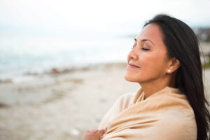 Smiling woman with her eyes closed in thought